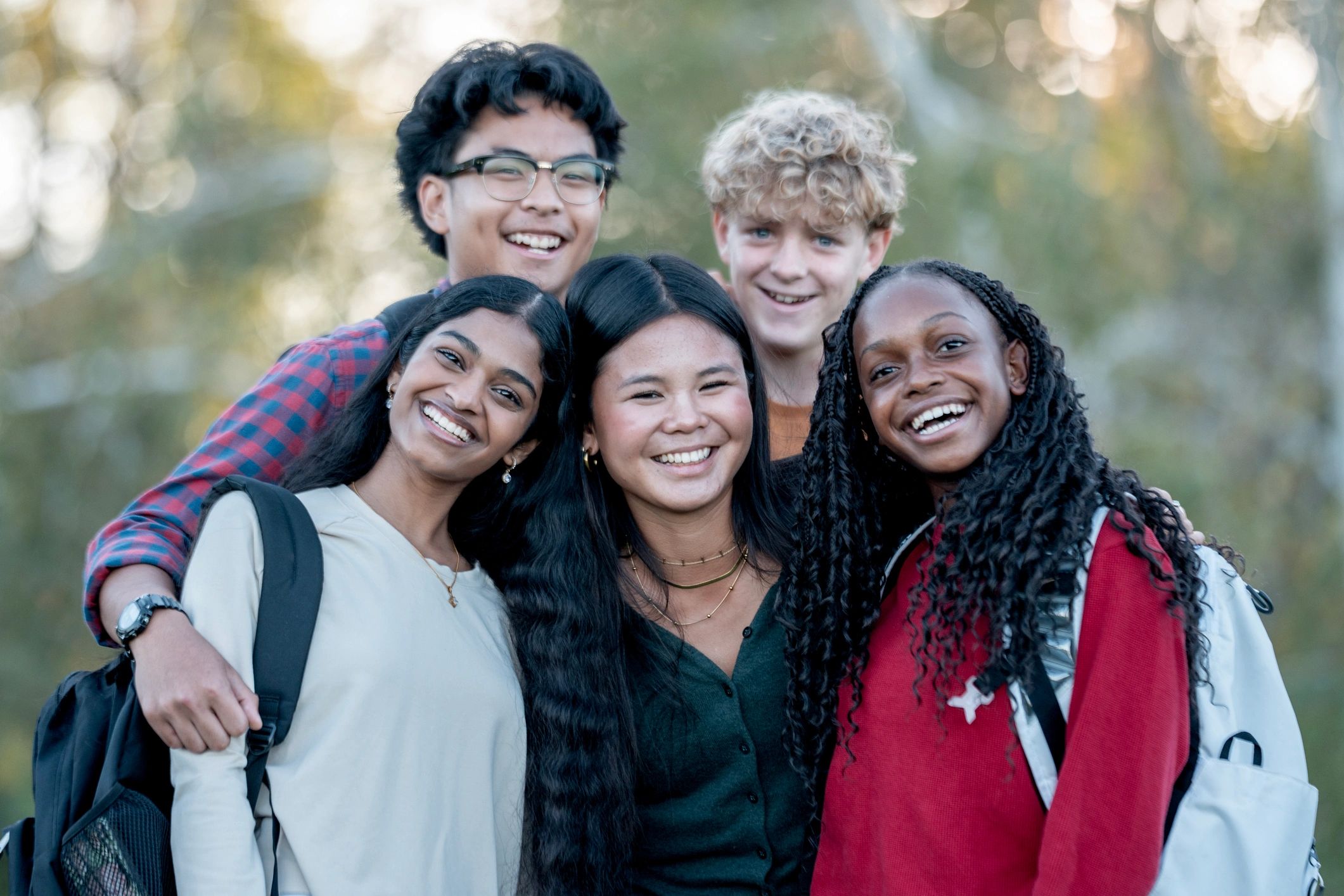 Diverse Group Of Friends Outdoors Sharing Smiles And Togetherness On Campus Life